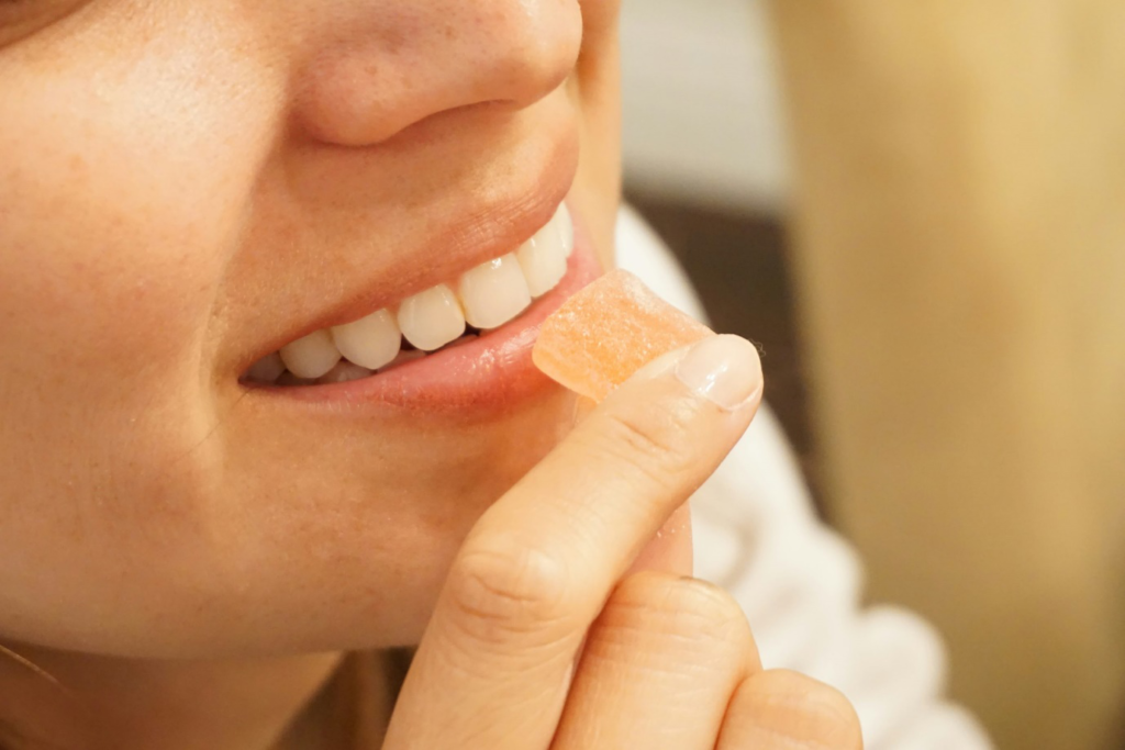 a person taking a hemp gummy