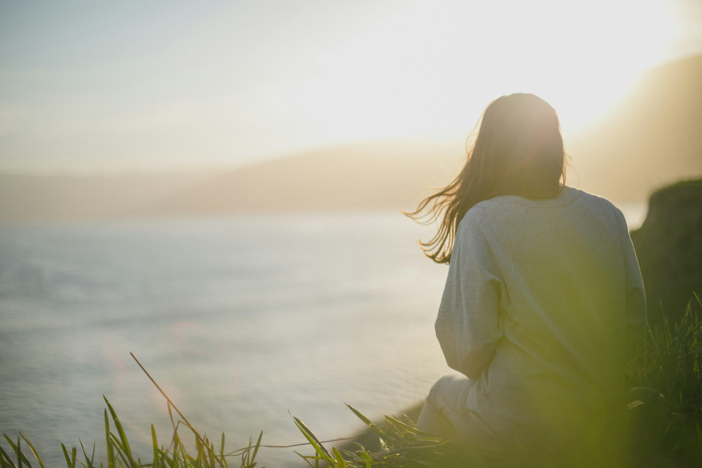 a person sitting by the water