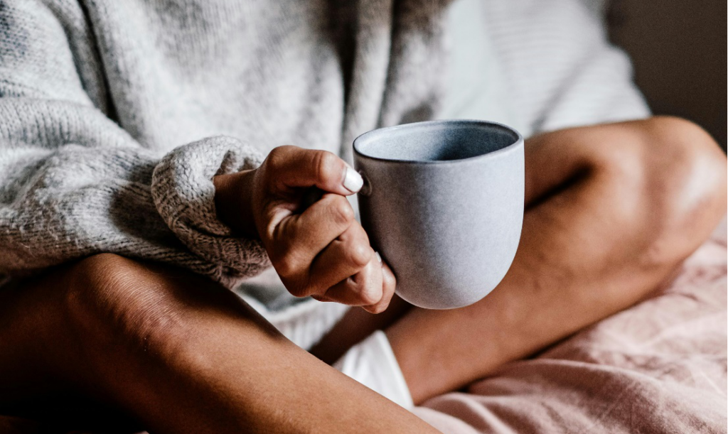 Woman cozily enjoying her beverage