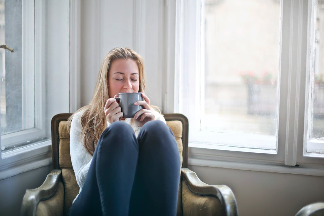 a woman relaxing by the window