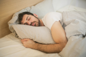 Man sleeping in a white t-shirt