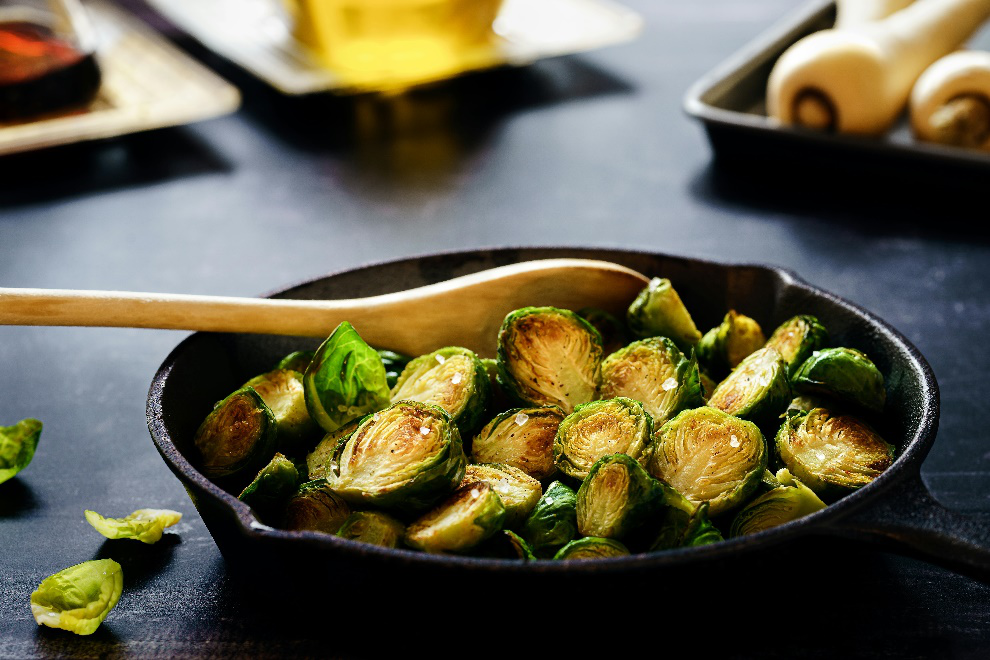 Wooden spoon lying amongst brussels sprouts