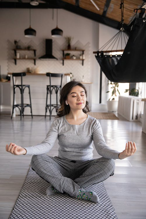 a woman sitting on a yoga mat