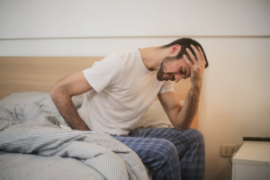 a man holding his head in his hand.