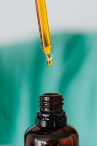 Close-up of a brown glass bottle full of CBD oil