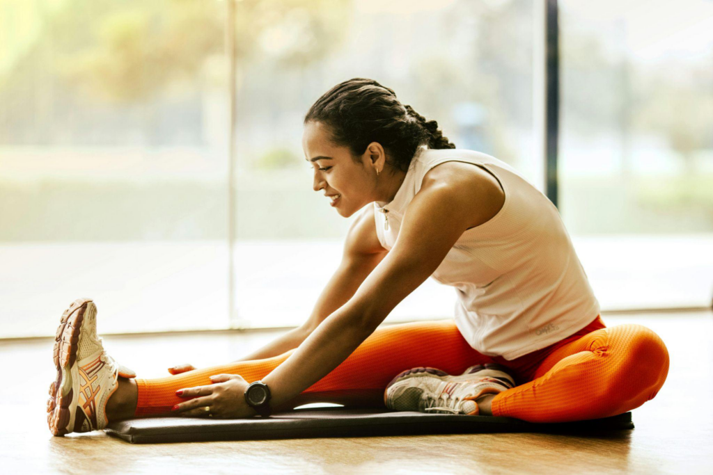 A healthy morning routine depicted by a woman stretching on a yoga mat. 