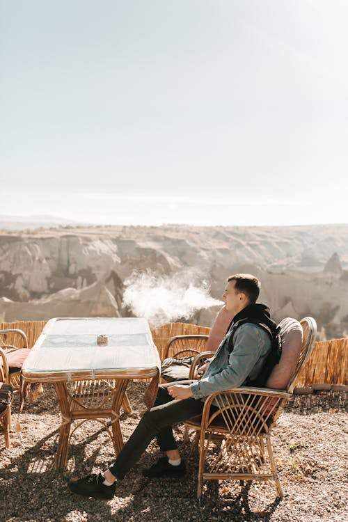 a man sitting in a scenic setting.