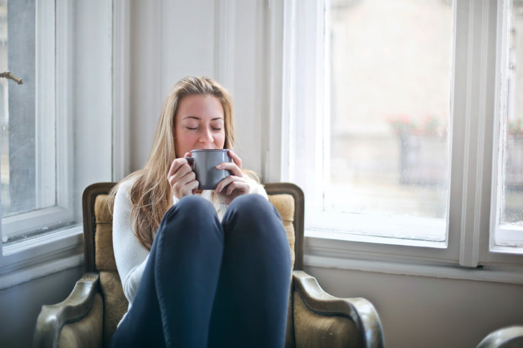  a woman relaxing by the window.