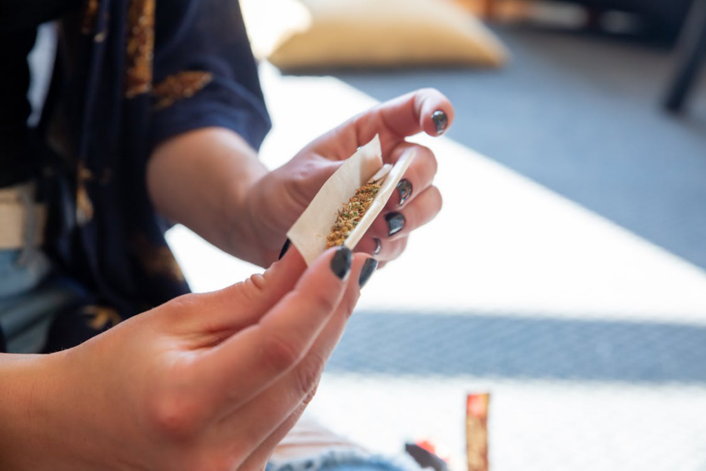 a person rolling paper.