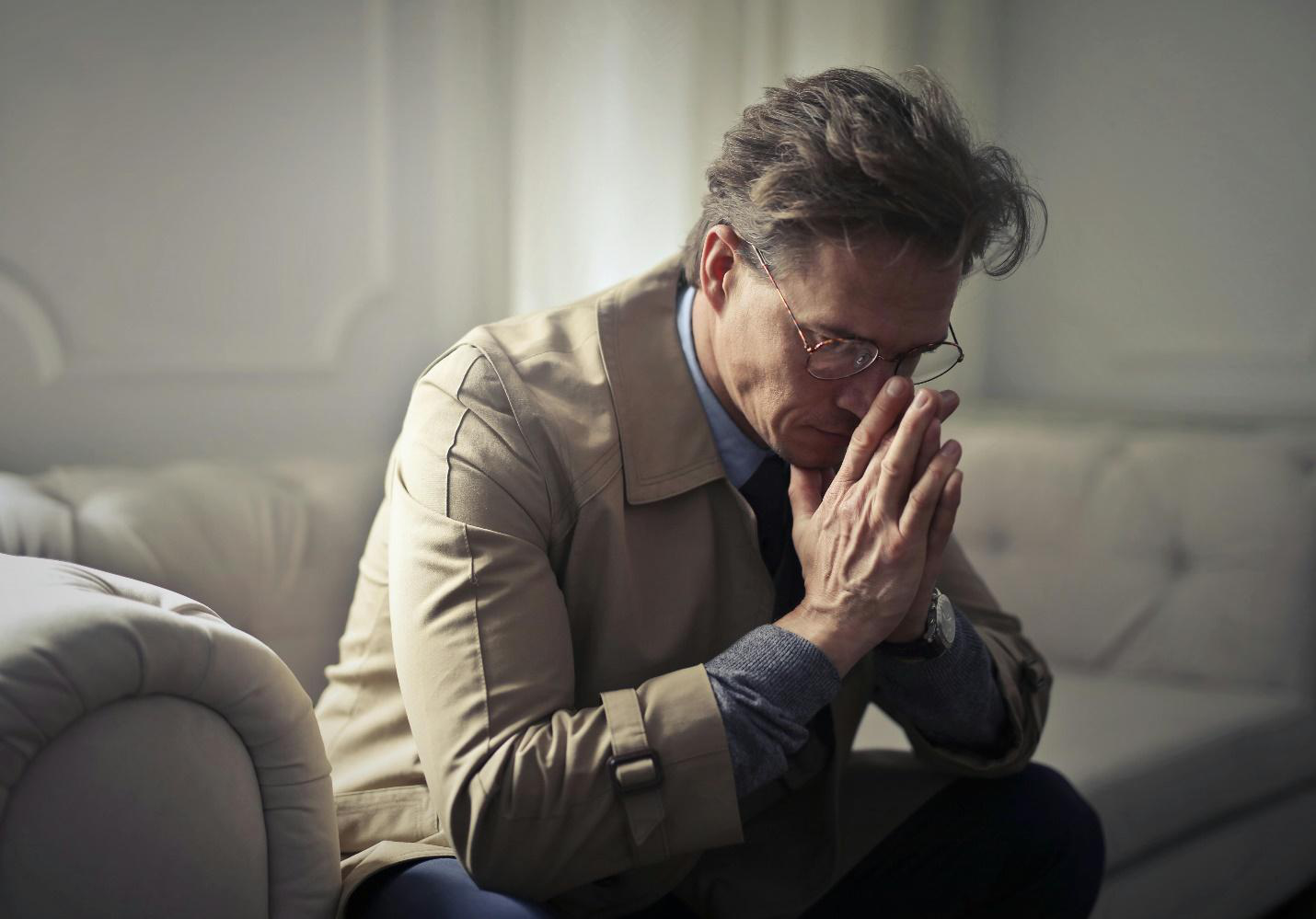 A picture of a stressed person sitting on a sofa