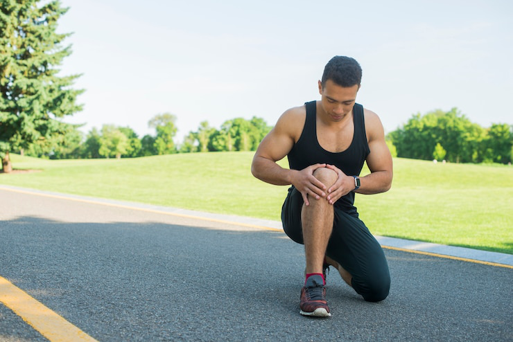 Person applying CBD to relieve joint pain