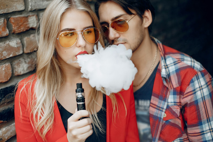 A lifestyle shot of a couple using CBD vape outdoors