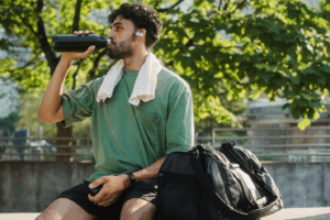 A picture of a person drinking water in gym attire