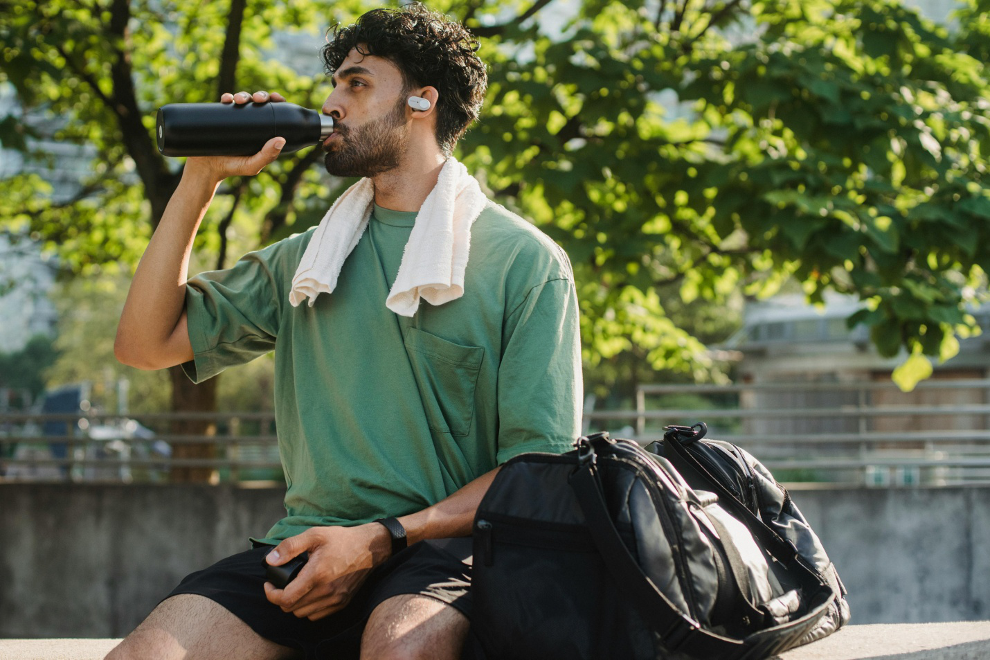 A picture of a person drinking water in gym attire