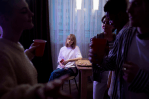 A picture of a person sitting alone at a party