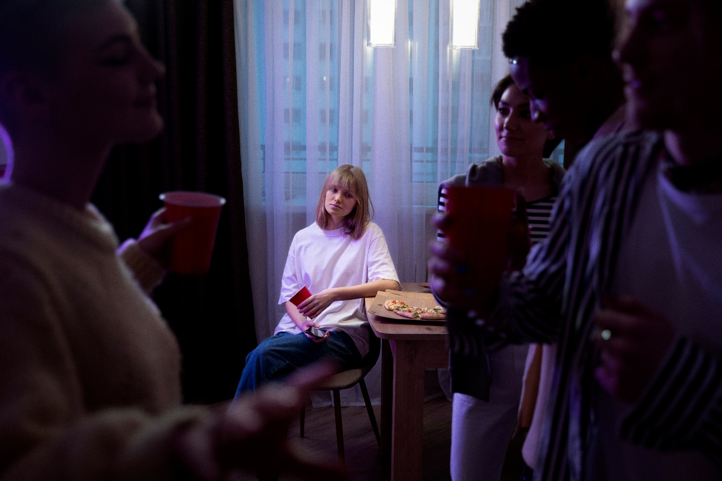 A picture of a person sitting alone at a party