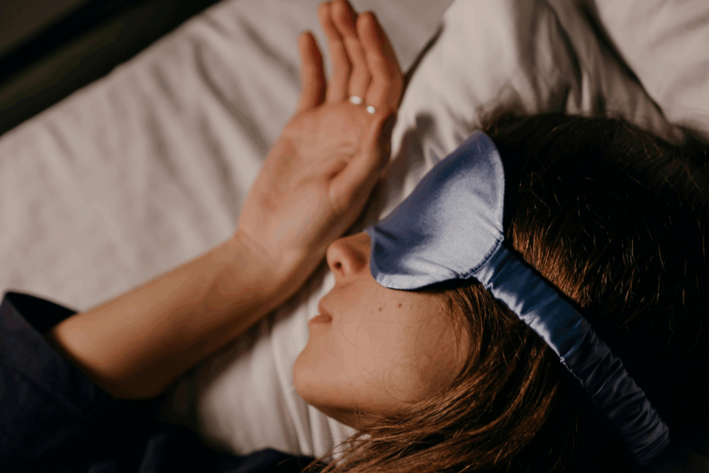 A picture of a person sleeping with a sleep mask on