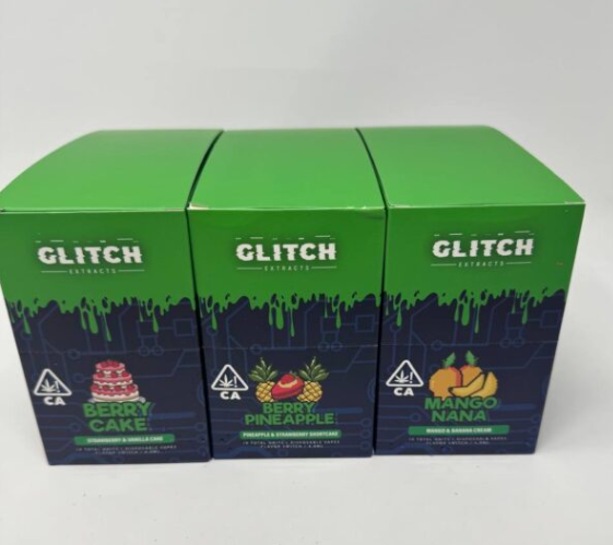 Three Glitch Extracts vape product boxes in berry and tropical flavors lined up on a white background.