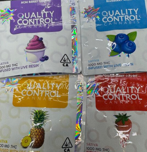 Assorted Quality Control Cannabis gummy digital art in vibrant fruit flavors, displayed with holographic foil packaging.