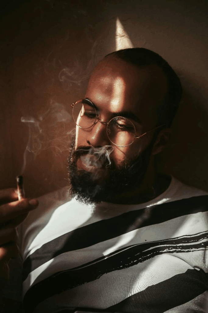 Man wearing glasses with calm expression.