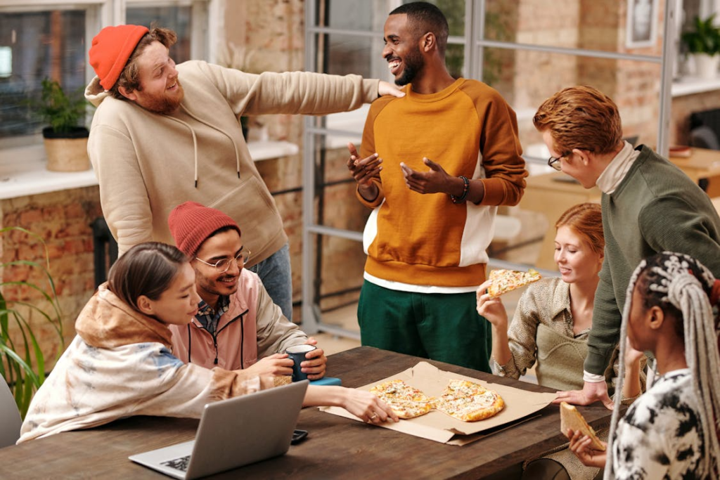 Group of friends sitting around a table enjoying a meal together