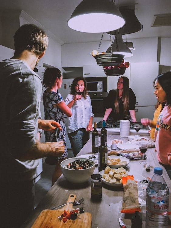 Group of friends enjoying wine and food around a dinner table