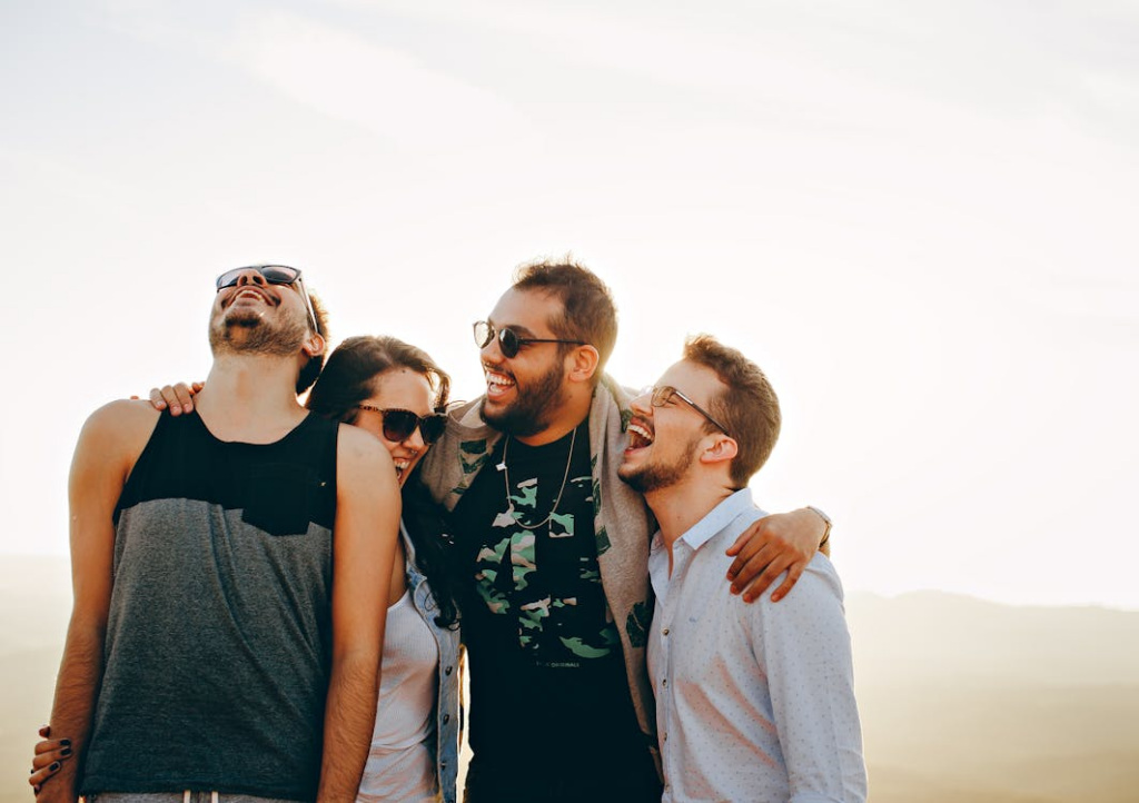 Friends laughing together outdoors in a relaxed social setting