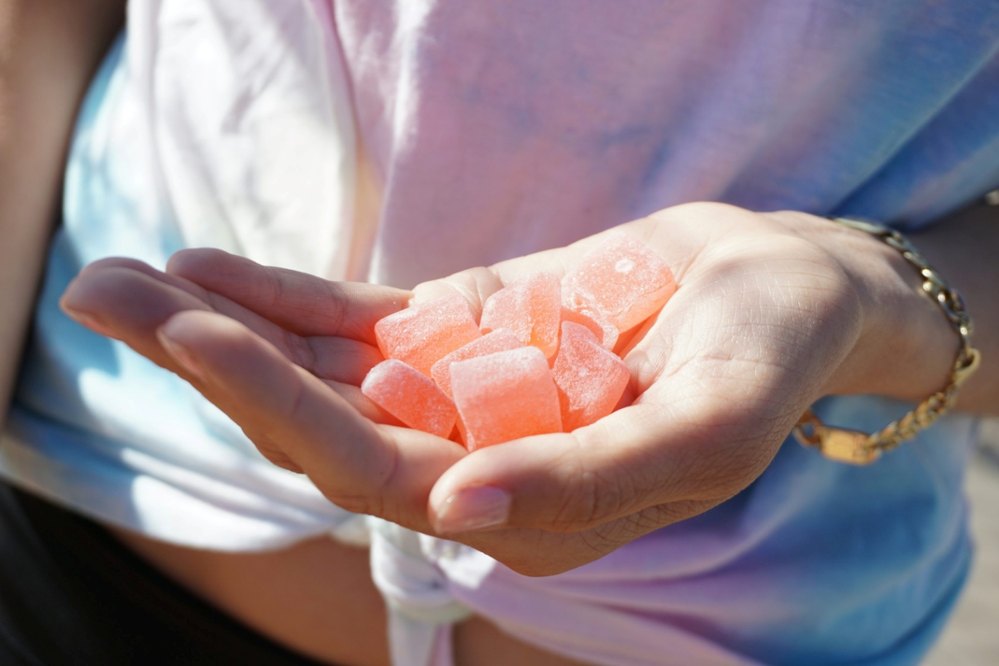 person holding orange medicine tablets