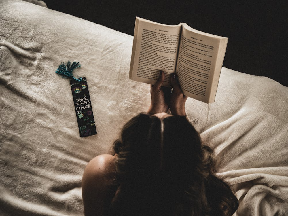 An image of a woman reading in bed