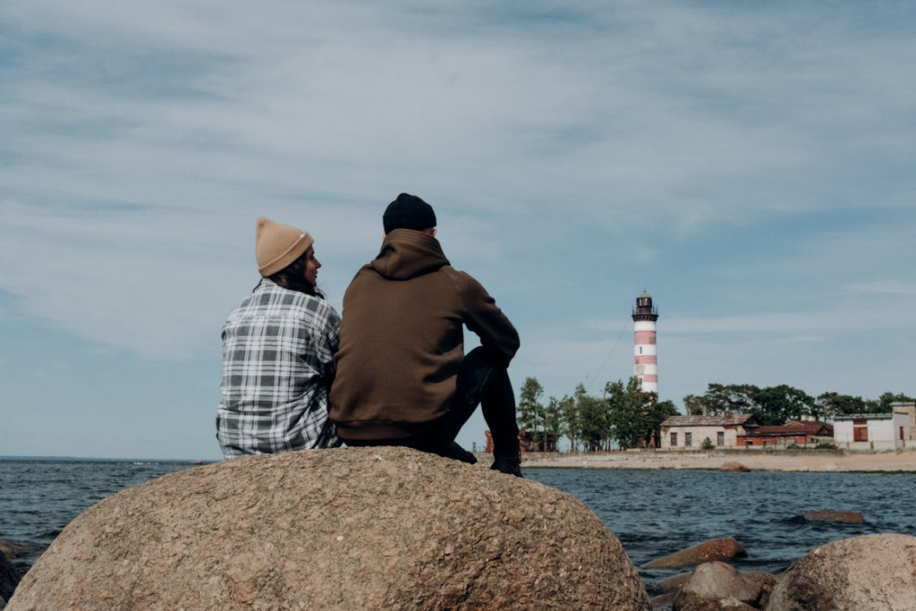 Group of people sitting together on rocks in a natural setting