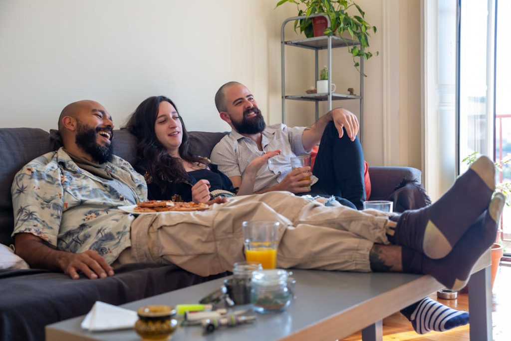 An image of friends relaxing on a couch