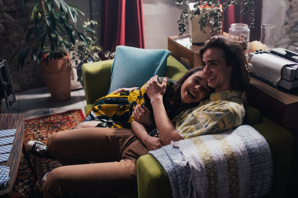 An image of a couple hugging each other on a couch