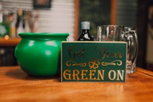 get your green on, written on a festive wooden bar