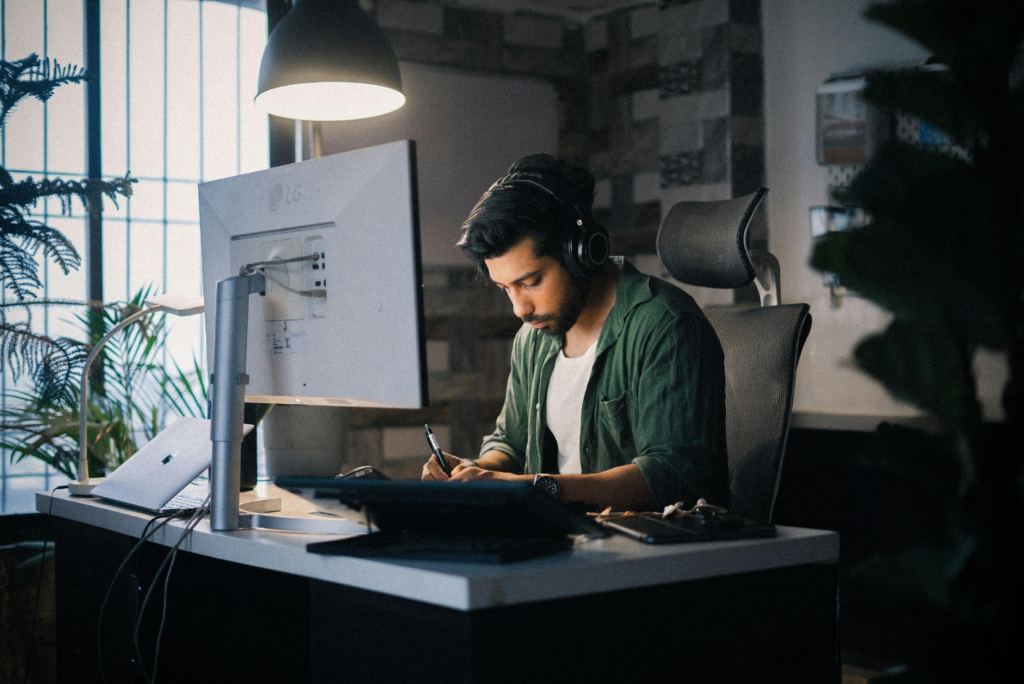 Person working at a desk in a calm and organized nighttime workspace
