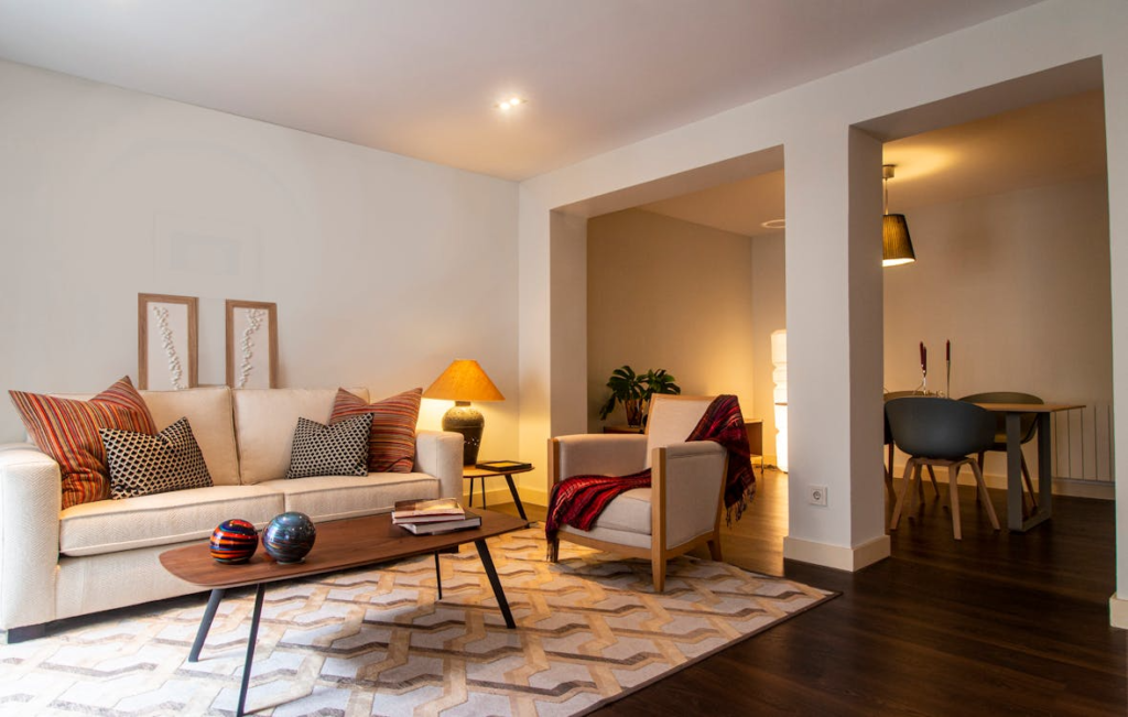 A stylish cozy living room with warm lamp lighting and comfortable seating
