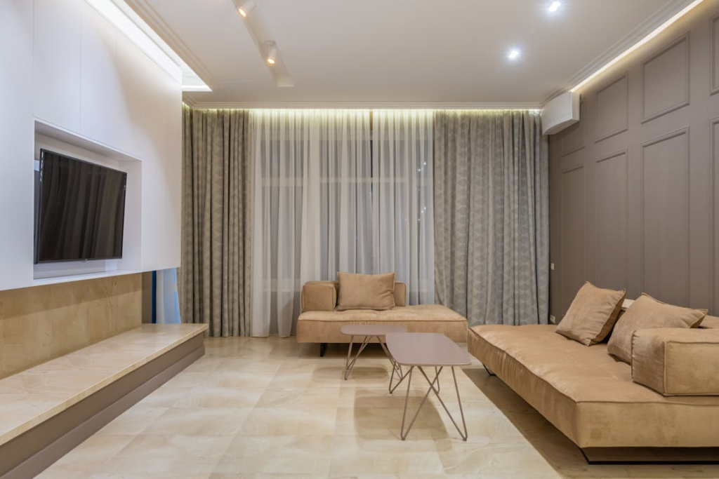 A cozy minimalist living room with soft couches and neutral-toned furniture