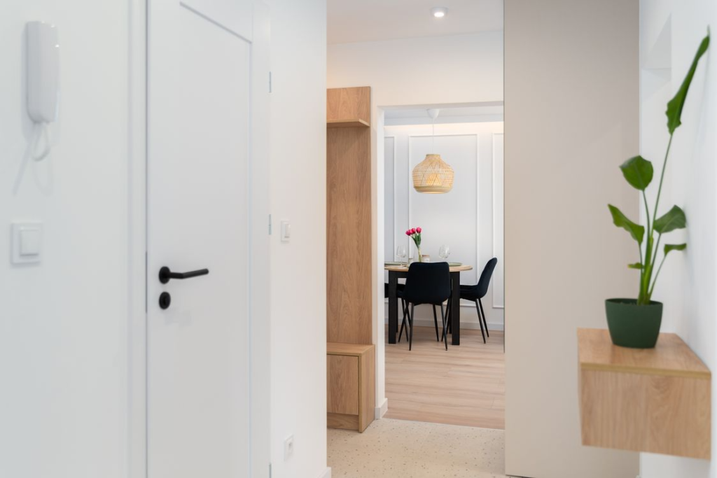 A bright modern minimalist apartment interior with natural light, clean design, and contemporary aesthetic.