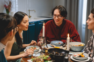 Four friends talking around kitchen table