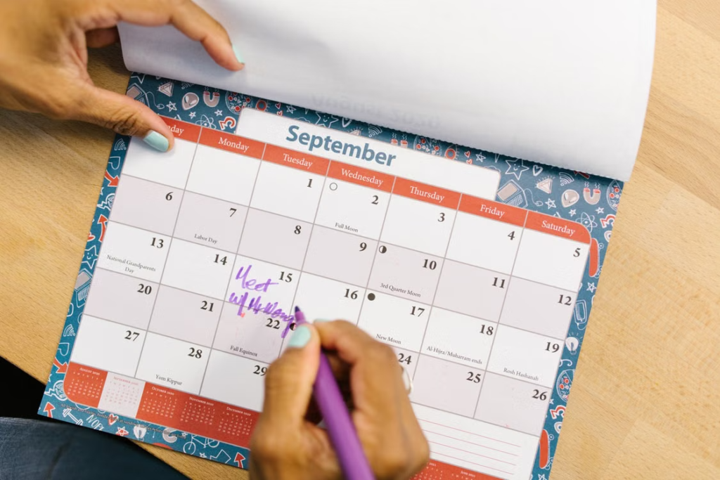 Person planning week at desk