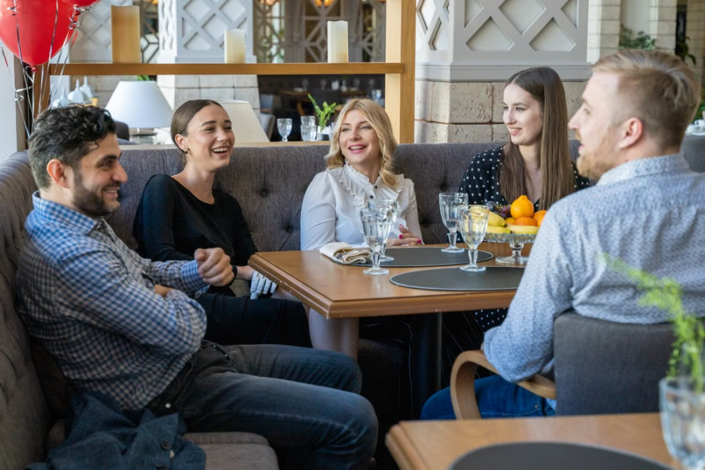 Friends talking in restaurant booth