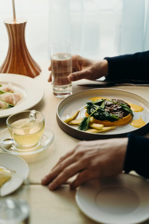 Hands setting a table