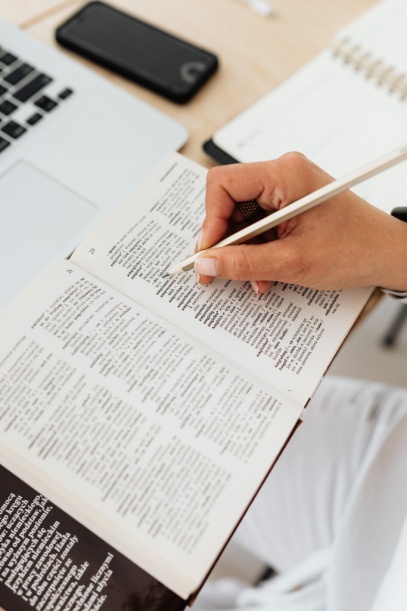 person underlining reference text