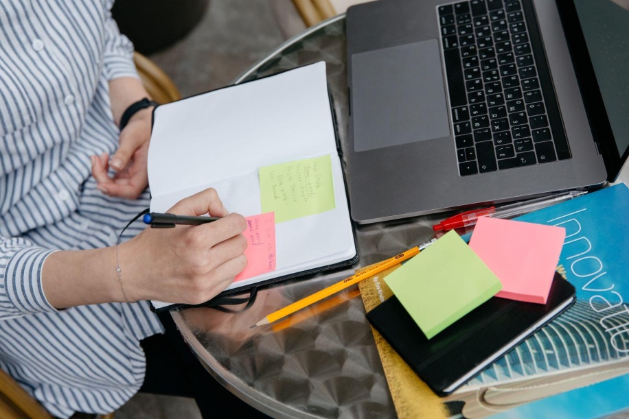 person writing sticky note