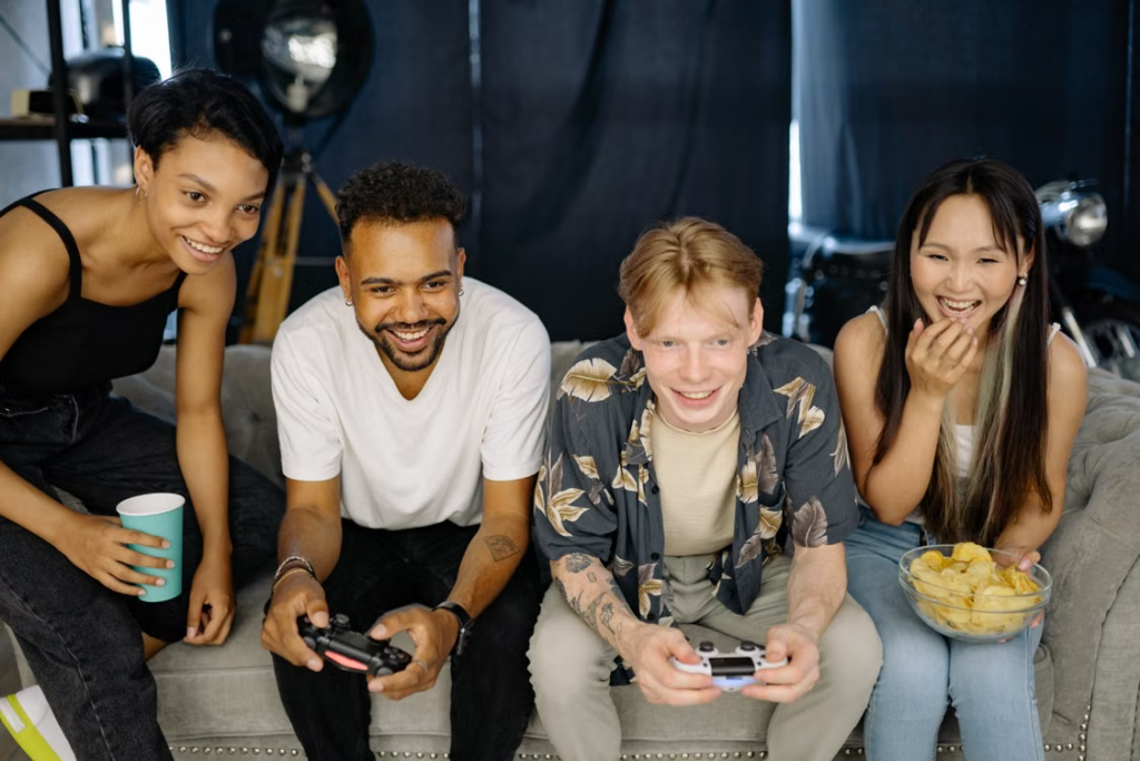Friends sitting together on a couch, enjoying a relaxed evening at home
